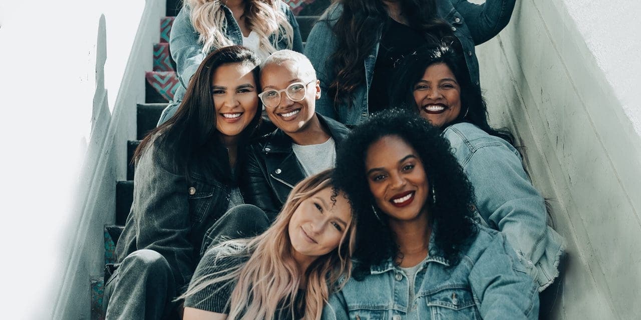 group picture of women sitting in stairs